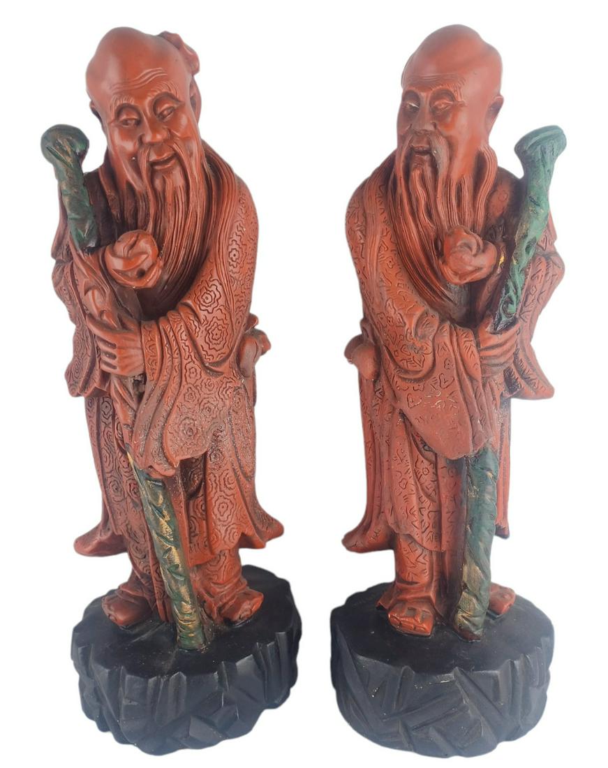Pair of Tall Oriental Coral Colored Elder Statues: Wise elders with a peach in their hand. Approx 15" Tall. They do show very minor wear. Collection Of Miguel A. Cruz Peraza