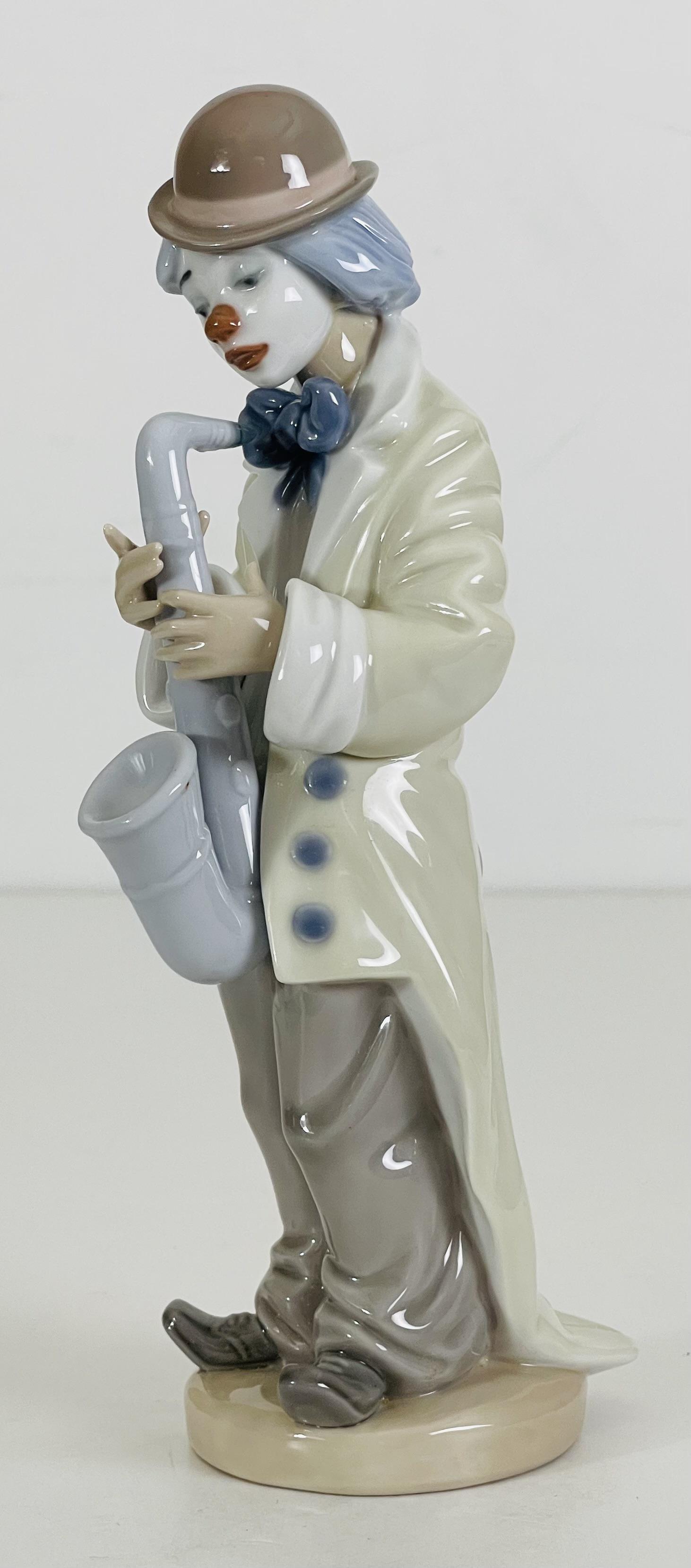 Lladro porcelain Clown with Saxophone figurine 5471: Lladro porcelain Clown with Saxophone figurine, 9" H x 3.50" W (in). Made in Spain.