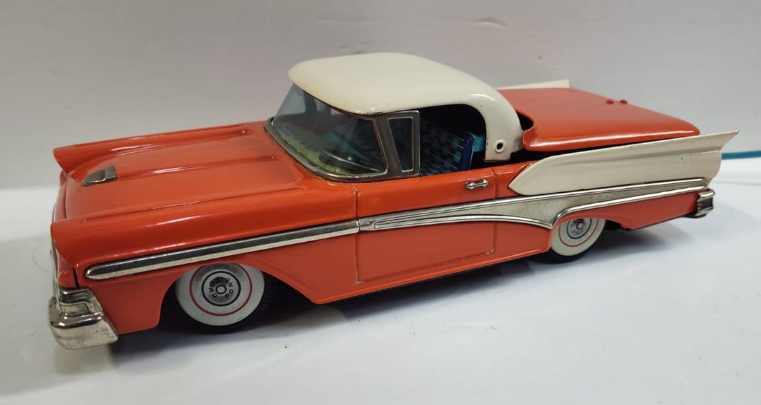 Vintage Battery Operated Tin Ford Convertible Toy Car.: Made in Japan, we believe by Cragstan. Toy Works with a convertible top going up and down as well as the toy moving forward and reverse. We believe the control was replaced at some point. Beautiful co