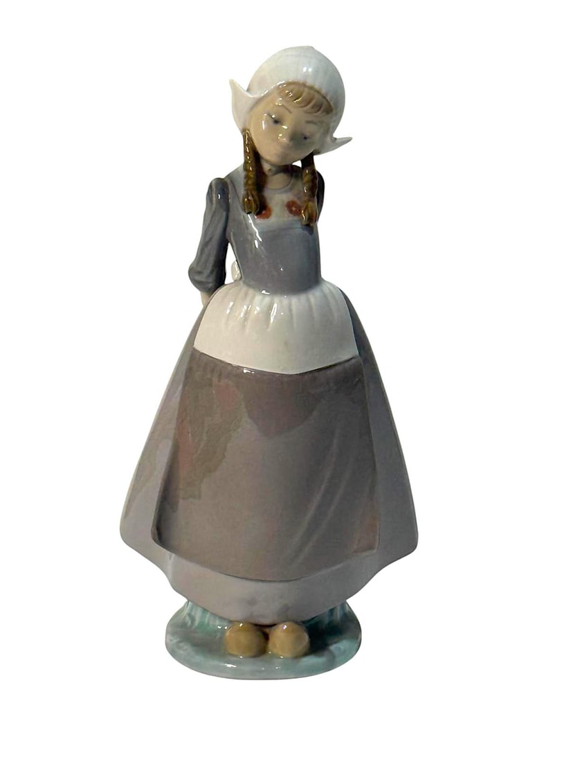 Dutch Girl, Kristina Lladró 5062.: Lladro Collection, Dutch Girl with arms behind, Kristina, Lladró, porcelain with a glazed finish. Ref. 5062. Sculptor Francisco Catala. Measurements: 10.25" high x 5.25" wide (inches). In perfect sta