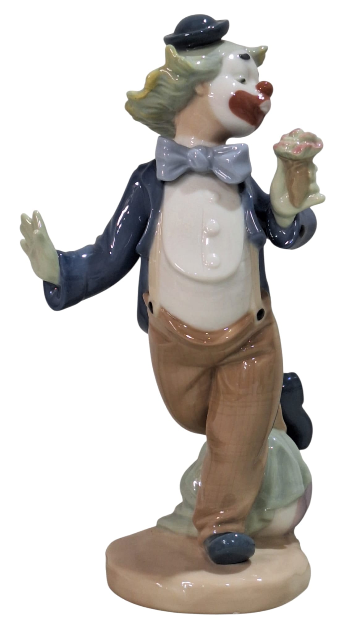 Flower for My Lady NAO by Lladró. 0488.: NAO by Lladro Collection, Hobo Clown Holding a Bouquet, NAO, porcelain with a glazed finish. Ref. 0488. Sculptor Salvador Furió. Measurements: 8.25" high x 4" wide (inches). In perfect condition. Wit