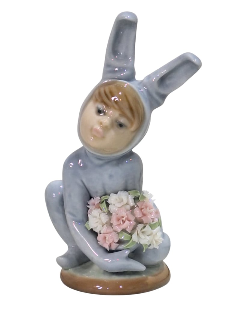 In the Meadow Lladró. 1508.: Lladro Collection, Nino Conejito Con Claveles, porcelain with a glazed finish. Ref. 1508. Sculptor Juan Huerta. Measurements: 4.25" high x 2" wide (inches). In perfect condition. With original sign. L