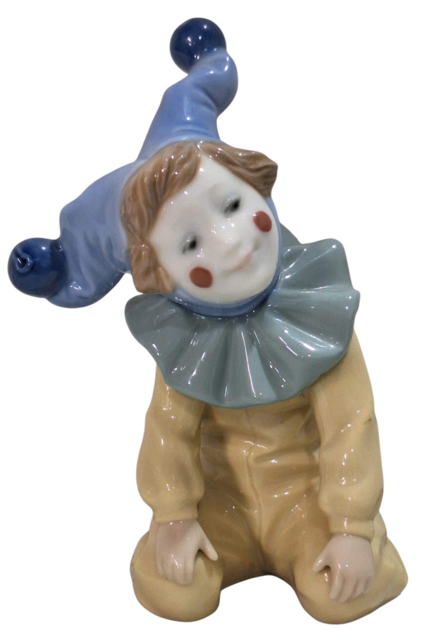 NAO by Ladró Collection. Small Jester Clown Harlequin Child.: NAO by Lladro Collection, Nao by Lladro, Kneeling Jester, NAO, porcelain with a glazed finish. Ref. 1067. Sculptor Salvador Furió. Measurements: 5.25" high x 3.50" wide (inches). In perfect condition