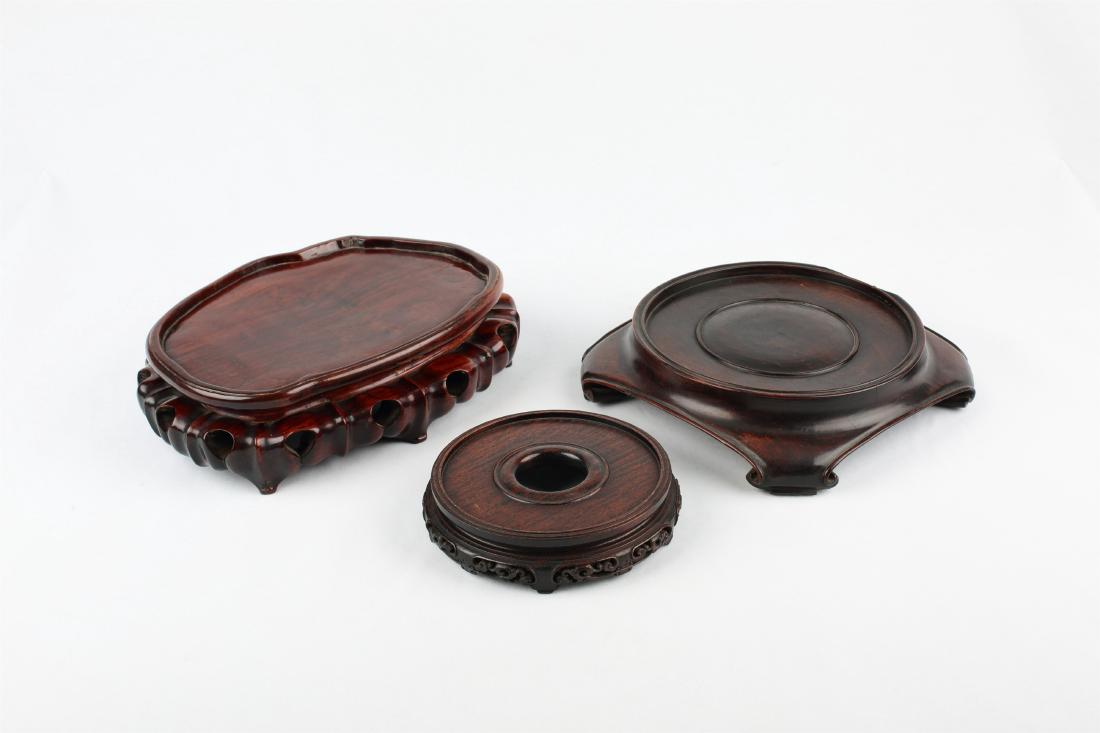 A SET OF THREE CHINESE WOOD STANDS (1 of 4)