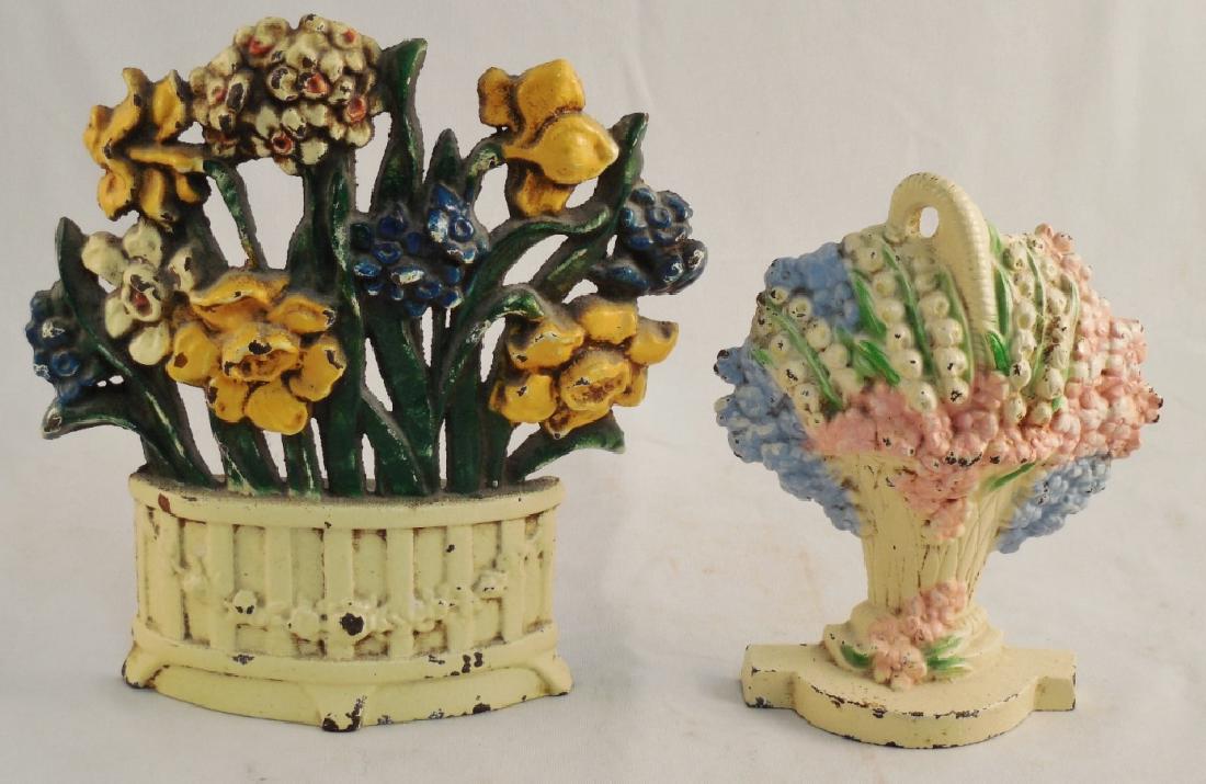 Lot of 2 Cast Iron Doorstops Floral: Taller one is 7 1/8" H and marked 52-575 and smaller one in basket marked 473