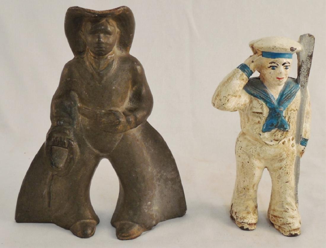 Lot of 2 Cast Iron Men: Naval soldier bank measures 5 3/4" H and cowboy doorstop measures 6" H