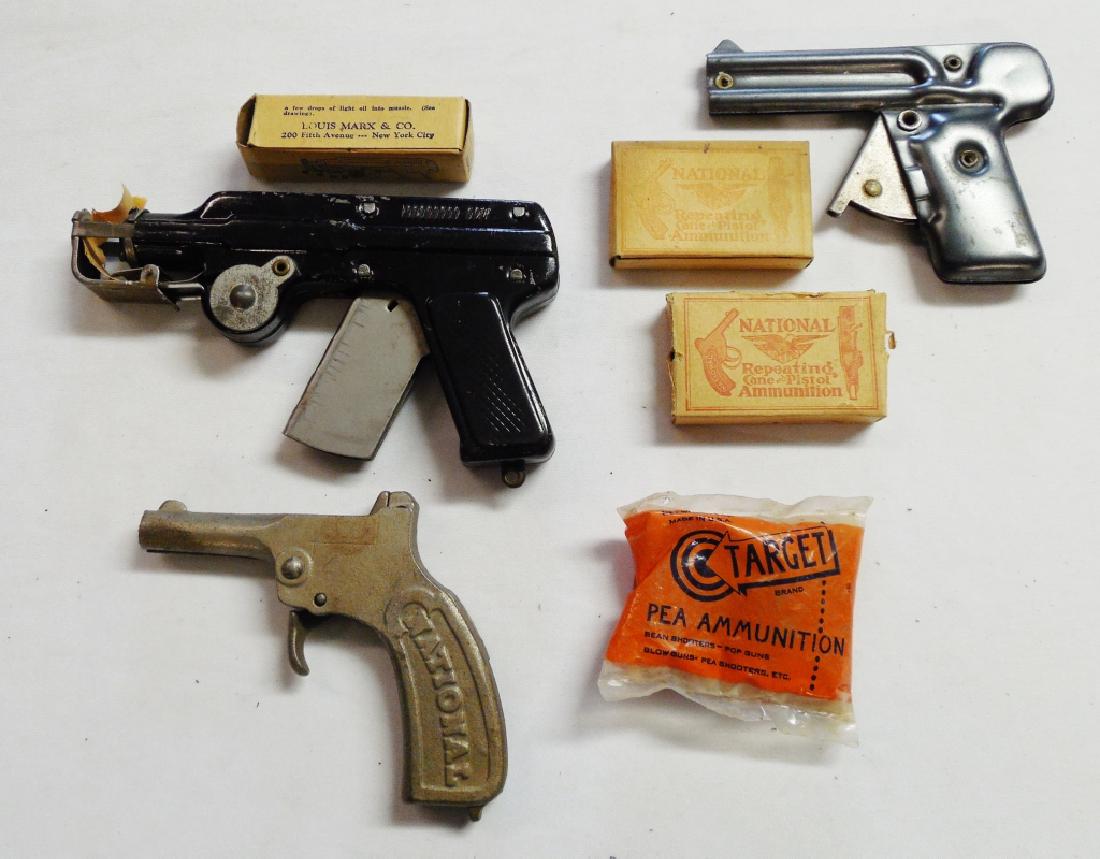 Lot of 3 Toy Guns: 1) Paper Pop Pistol with ammo NOTE: DOESN'T FUNCTION FULLY, 2) National Repeating Pistol with ammo, and 3) Pea-Matic with ammo