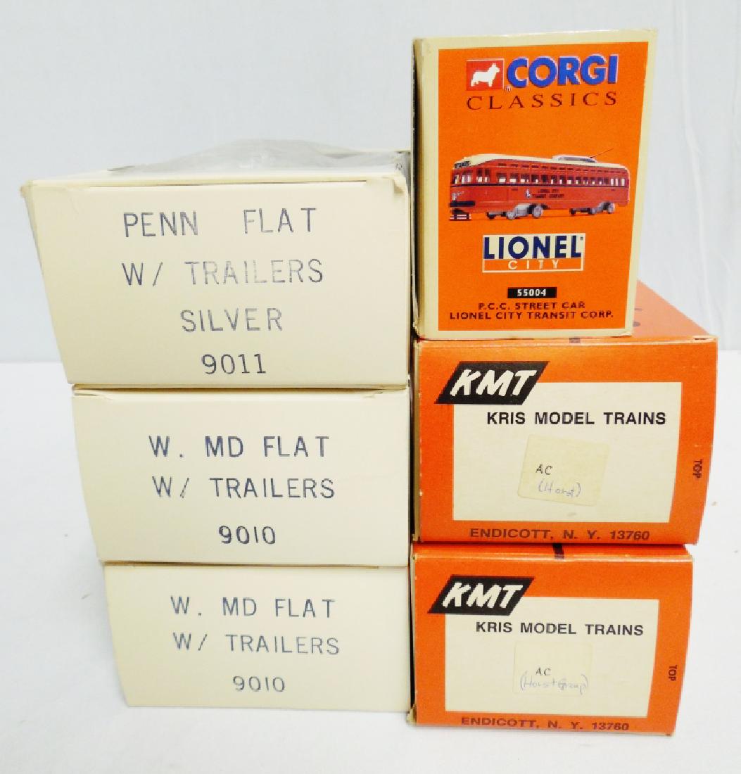 Assorted Lot: Corgi Lionel Transit Car, 2 Kris Model Trains with boxes, 3 Flat Train Cars with trailers