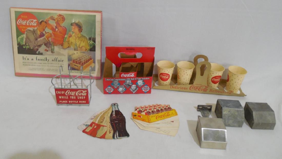 Assorted Coca Cola Collectibles Lot: advertisement, paper cup carrier with cups, bottle holder for shoping, 2 souvenir folders, and more