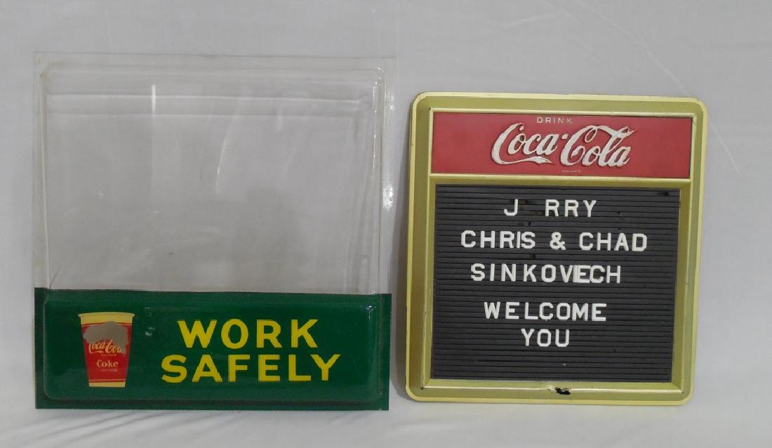 Lot of 2 Plastic Coca Cola Signs: Work Safely measures 14 1/2" H x 8" W, NOTE: BOTH HAVE DAMAGE