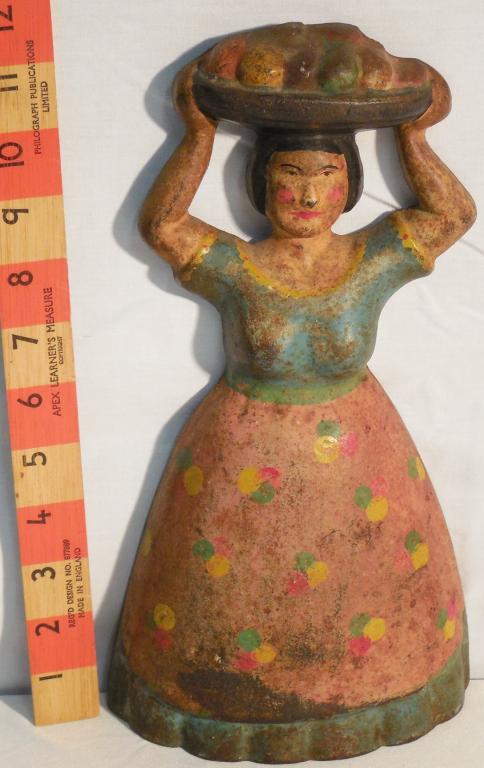 Cast-iron Lady with fruit basket on head: 11 3/4 inches tall cast-iron doorstop see photos Excellent Condition