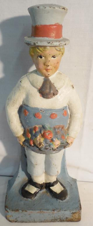 1 Cast-iron doorstops Hubley Boy l: Boy holding fruit basket 9 inches tall excellent condition