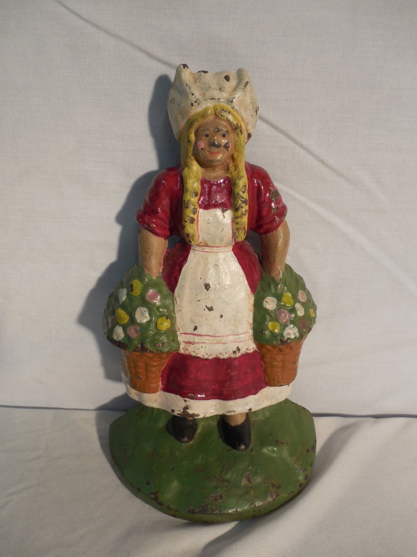 1 Cast Iron Doorstop Dutch Gril: Dutch Girl with flower basket 9 1/2 inches tall excellent condition