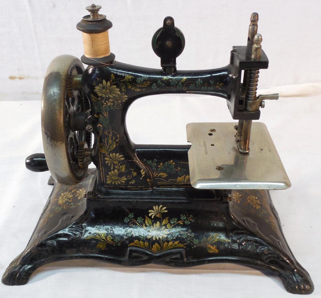 Heavy Cast Sewing Machine made in Germany-: very fancy paint-little wear on wheel-As is-See Photo