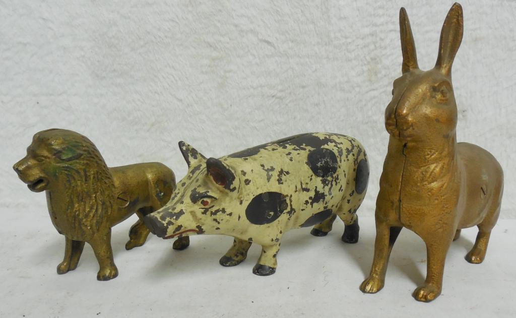 Lot of 3 Cast Iron Banks Pig / Rabbit / Lion pig has (1 of 5)
