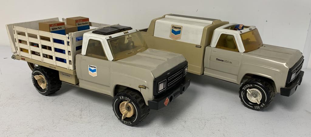 lot of 2 Tonka Chevron Trucks w/ Drivers: one truck may be missing the sunroof, both trucks have wear, one truck has numerous barrels and crates