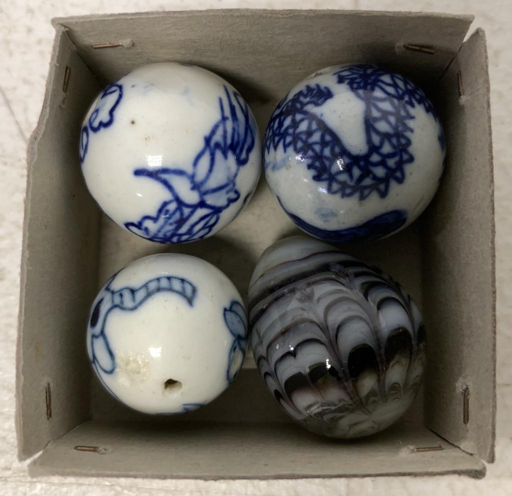 4 Marbles all with 3/4" diameter: three white ones with blue decorations and animals have holes on the ends, kind of lighter weight, blue one is egg shaped