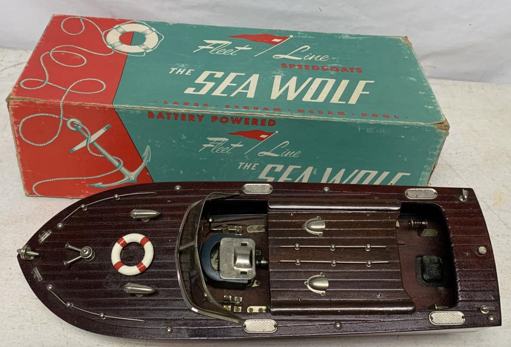 Fleet Line The Sea Wolf Speedboat Orignal Box: battery operated, untested, top wooden piece may be broken off of boat, some light scratches on hull, box lid has some damage on corners, rudder & flag in box but noit attached to boat, steering wheel