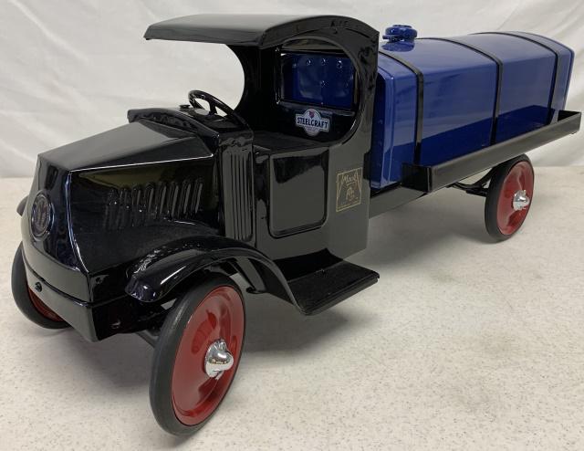 Reconditioned Steelcraft Mack Tanker Truck: small amount of blue paint chipped behind passenger door, flat spots on tires, scratch on top of driver side fender
