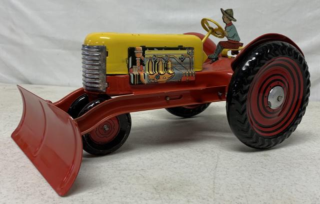 Tin Tractor: when you push the tractor, the axle clicks, scratches and wear here and there, no names or markings, only marking is an exclamation point on front tires, litho of man on tractor has some wear, handle/