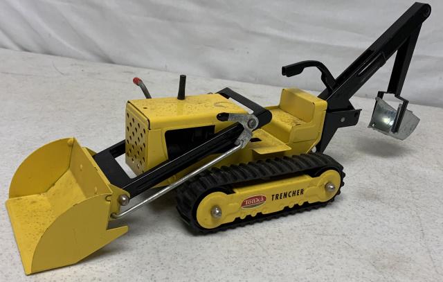 Tonka Pressed Steel Trencher: pitting on yellow paint throughout the top, handle moves scoop up and down, light wear, handle and scoop work, something missing from console as there is a large hole there