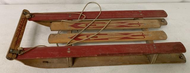 Torpedo sled made in Canada: wood shows wear with head cross bar being split