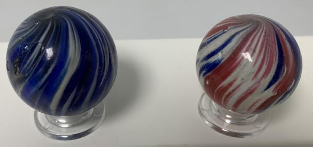 2 red/white/blue,blue/black swirl Marbles: 1 15/32" blue/black,large hole on side,1 3/8" red/white/blue has scratches