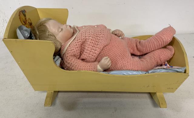 Sugar Britches reproduction bisque baby: of a Boots Tyner design 1986, in a child's doll cradle