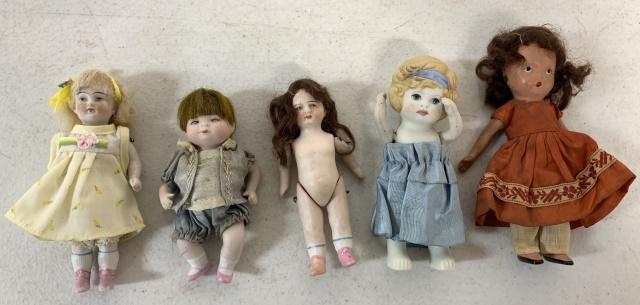 5 small bisque dolls: Nancy Ann story book doll, one in yellow is German with marks as shown, baby is copyrighted Grace Putnam Germany, one made in Japan and the one without clothes is marked up under the hair