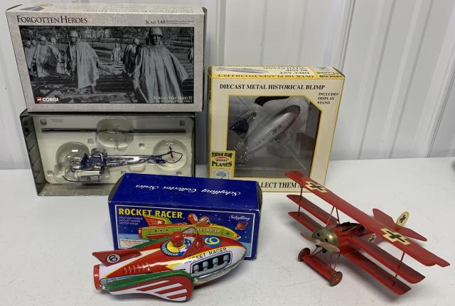 Helicopter, blimp, Fokker and Rocket racer: Corgi Forgotten Heroes Bell H-13/HTL-USMC-HMX-1 in box; Postage Stamp Planes Blimp in box; Schylling Rocket Racer in box; Fokker plane