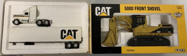 2 Ertl Caterpillar toys in boxes: #2676 5080 Front Shovel, #7712 Caterpillar Cab w/Trailer( box shows lots of shelf wear)