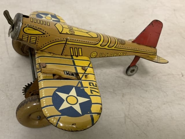 Marx wind-up sparking plane: shows scratches and wear; key wind-up does not work; one flint worn off the other is missing