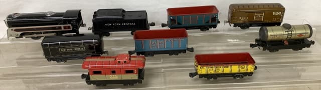 lot of 9 Marx Tin & Plastic Trains & Others: engine untested, New York Central car unmarked, lithos have some wear and some scratches, couple with light rust, probably O gauge