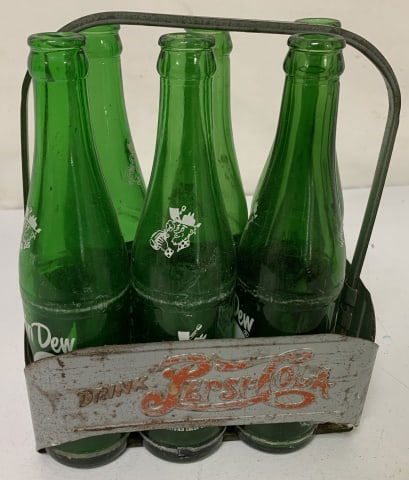 metal Pepsi carrier w/ 6 Mountain Dew bottles: carrier shows paint losss and rust, bottles show wear