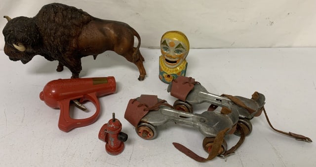 tray lot of toys: Chein clown bank, Ringling Bros. gun, fire hydrant, skates, bison figurine; see photos for conditions