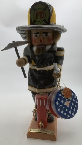 signed Steinbach fire fighter nutcracker: hose reel is music box; some wear to coat fabric