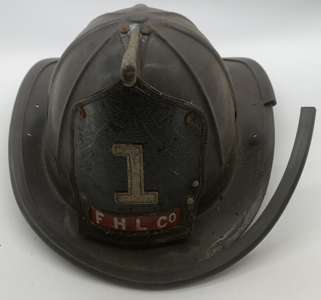 FHL Co. fire helmet: brim trim is brittle and loose, insides are gone; leather name plate is loose and has cracks