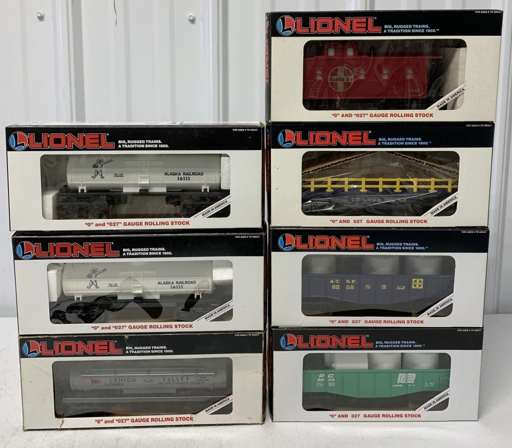 7 Lionel tank cars, gondolas and caboose: O & O27 gauge; Alaska and Lehigh Valley Dome Cars, Penn Central and Santa Fe Gondolas, Santa Fe Flat Car and Caboose; boxes have wear