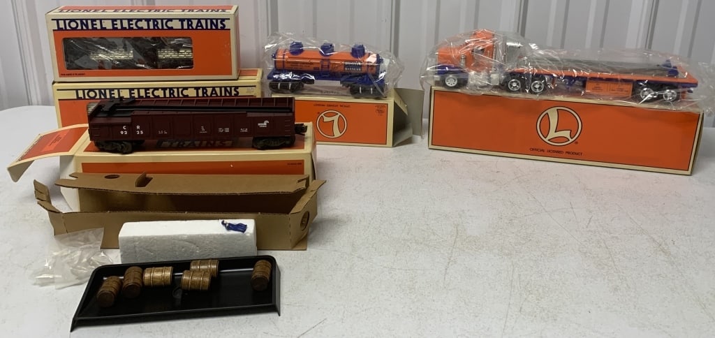 5 Lionel cars and Truck in boxes: O gauge; Flat bed Truck with Tank car( are in separate boxes); Conrail Barrel Car; Carson City Mint Car; Virginian stock car; boxes have light wear