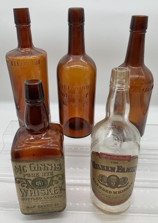 5 Whiskey bottles: Hollywood Whiskey, Telegram Rye, Humphrey & Martin, Mc Ginnis and The Wilken Family; all bottles show wear, some damage to paper labels