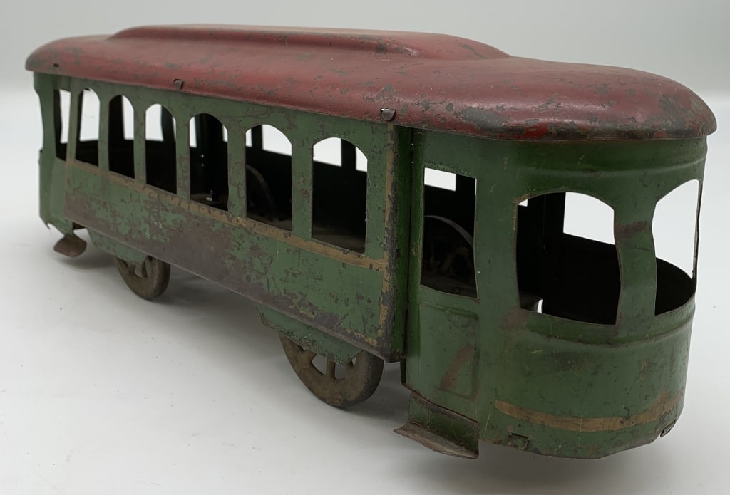 Heavy tin Streetcar: no names or markings, lots of worn paint, scratches, wheels turn, some dents by the window frames and near the doors, 16" long