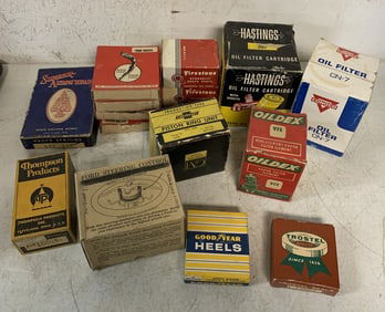lot of vintage automotive parts in boxes