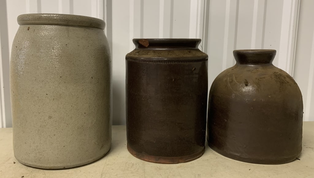 3 stoneware and redware canning jars: redware has lip chip and chips at base; all show wear