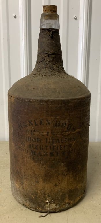 Hanlen Bros. Liquor Harrisburg PA bottle: has damage to bottle wrap and the bottle bottom is cracked as shown