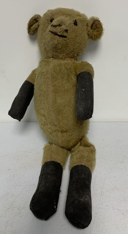 jointed teddy bear: shows wear with some damage and repair stitching; threadbare at places