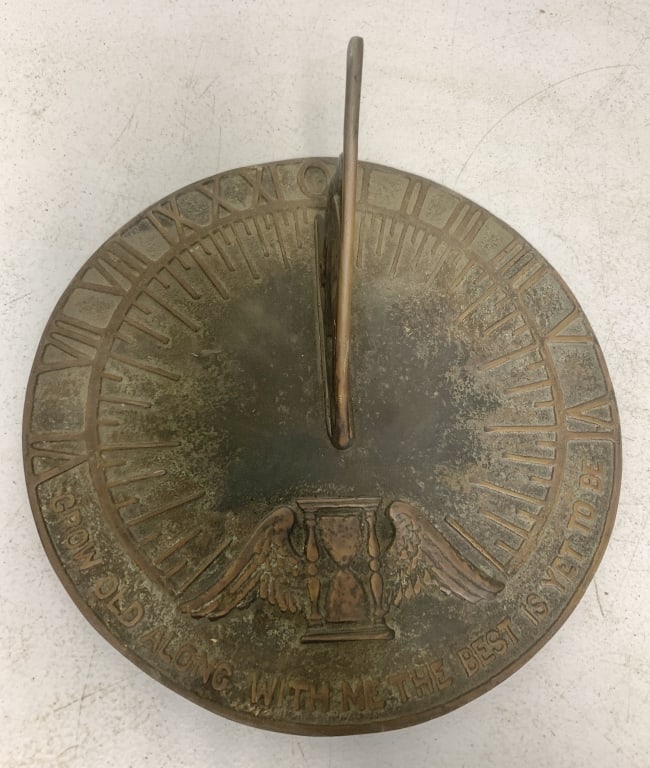 brass sundial: has wear with initials scratched in bottom