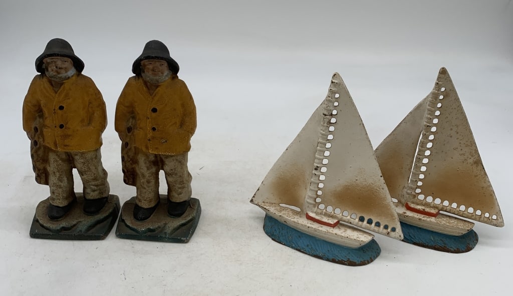cast iron salty mariner and sail boat bookends: both have wear with paint loss and rust