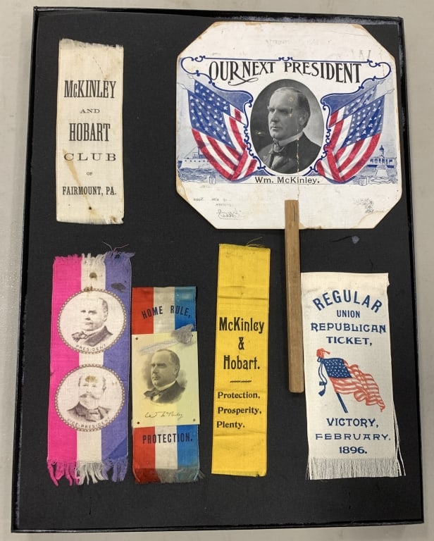 McKINLEY SIX RIBBONS & HAND FAN PRESIDENTIAL CAMPA: Largest is 12 " long fan that has De Soto,IA advertising with graphics of "Black Joe" and "White Sue" on verso. All are VG to VF.