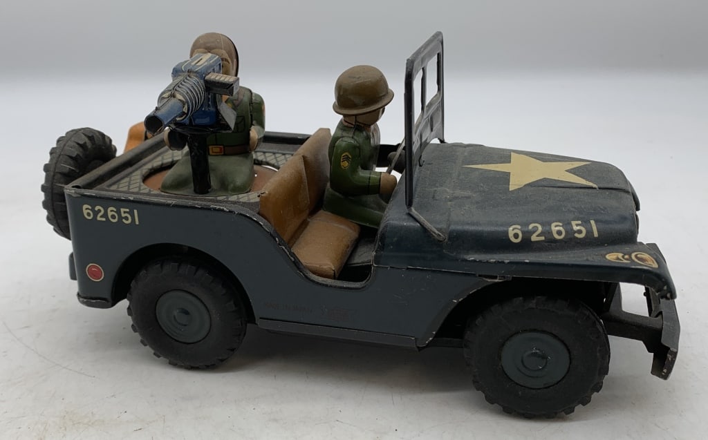 Showa tin friction military jeep: has wear with scratches and paint loss, soldier missing helmet; friction works