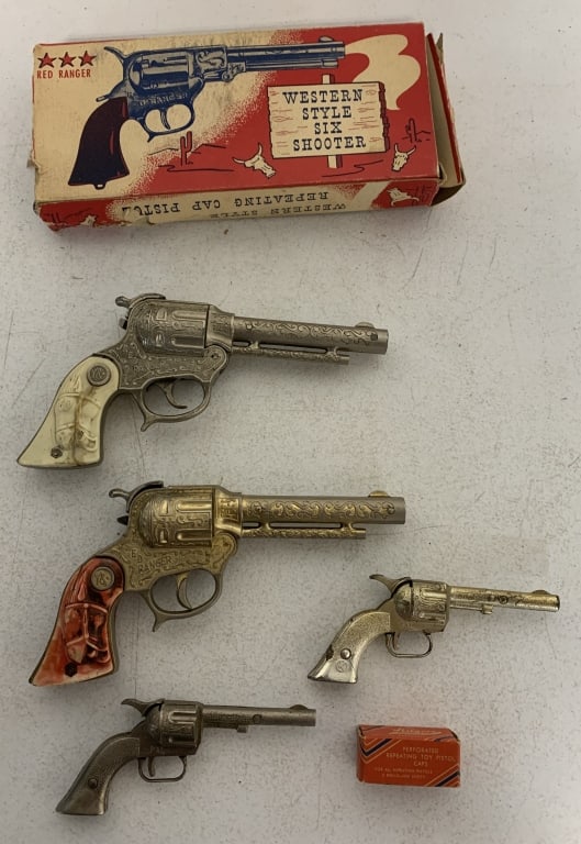5 cap guns and a box of caps: 3 Red Rangers, 1 in box(box has damage), other two have broken grips and only one of them works; all show wear